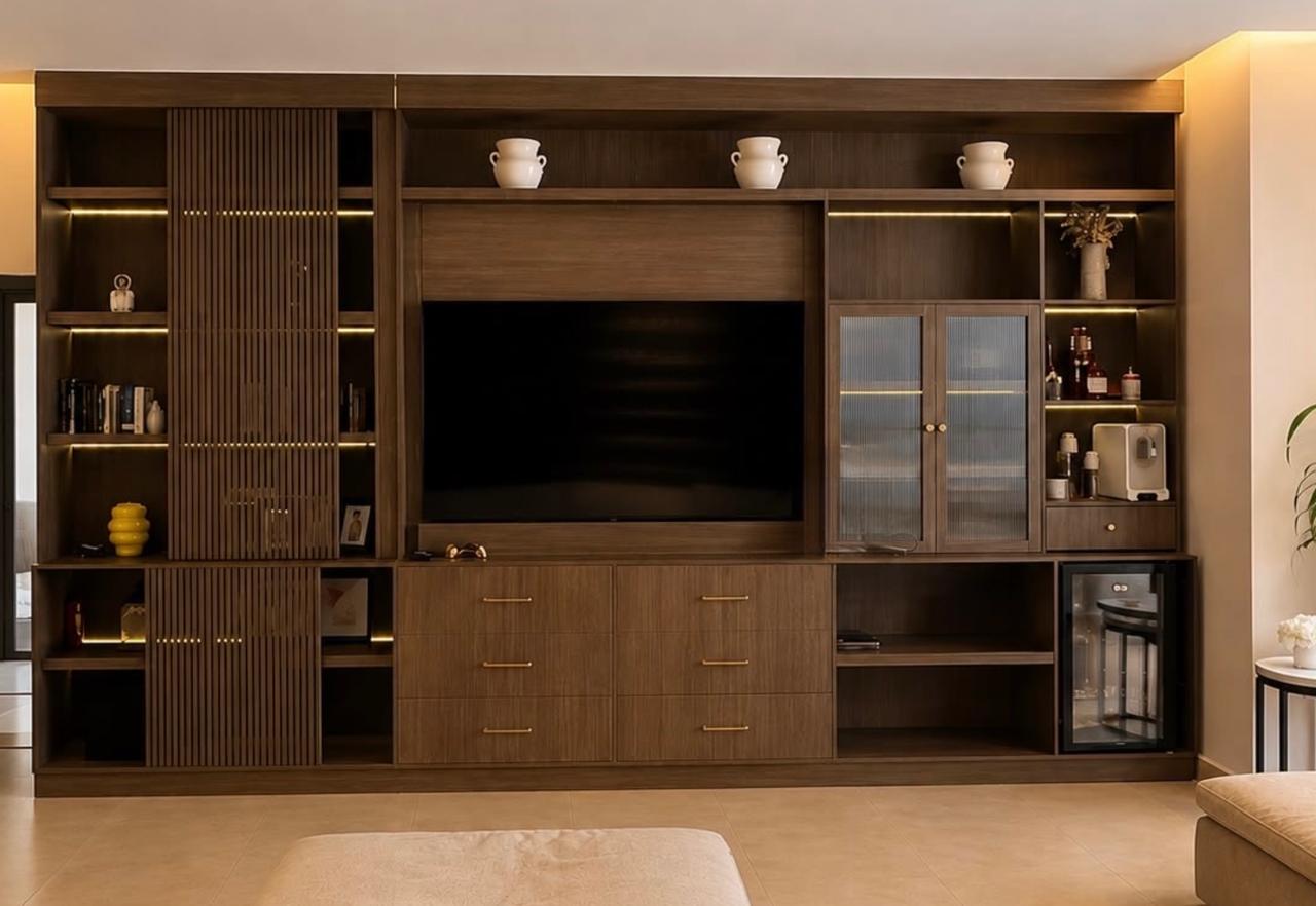 Living room media wall with fluted panels, glazed cabinets and lit shelves