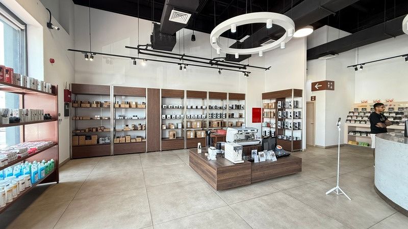 Coffee equipment store with walnut display walls and island counter