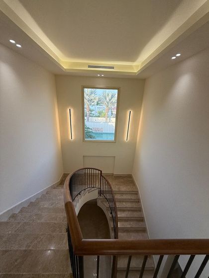 Staircase with timber handrail and cove lighting