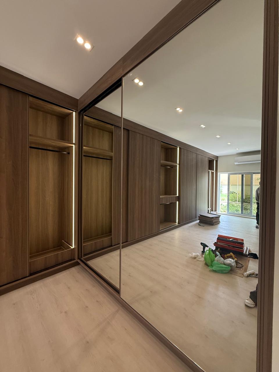 Mirrored wardrobe doors reflecting the fitted room