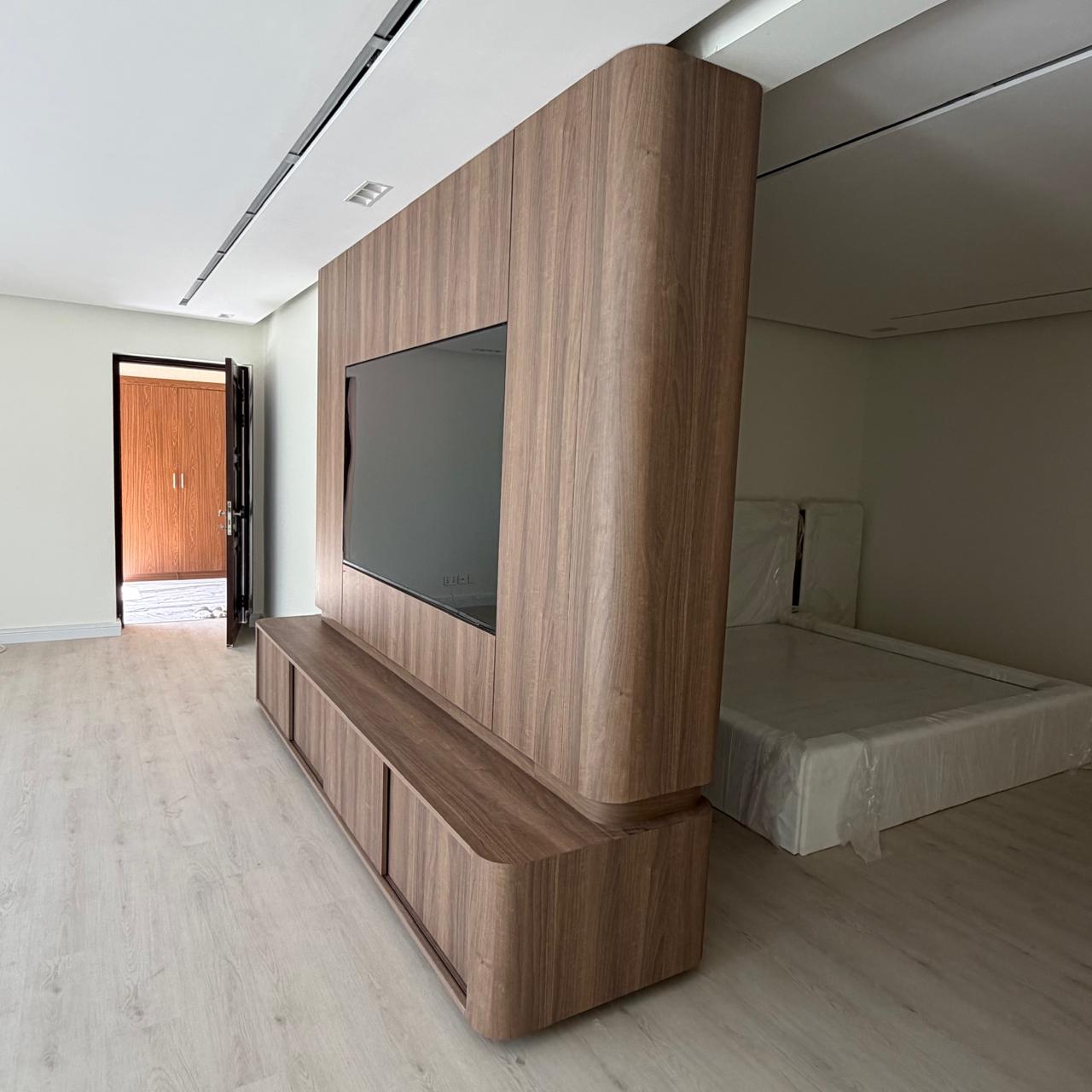 Freestanding TV unit with curved timber ends and low storage